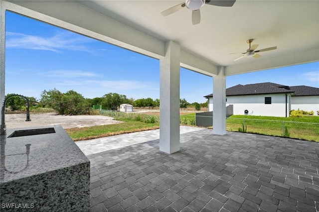 3631 68th Ave NE, Naples, FL 34120 - view of patio / terrace featuring an outdoor structure, fence, ceiling fan, and a sink