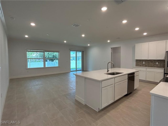 kitchen featuring dishwasher, visible vents, open floor plan, and a sink