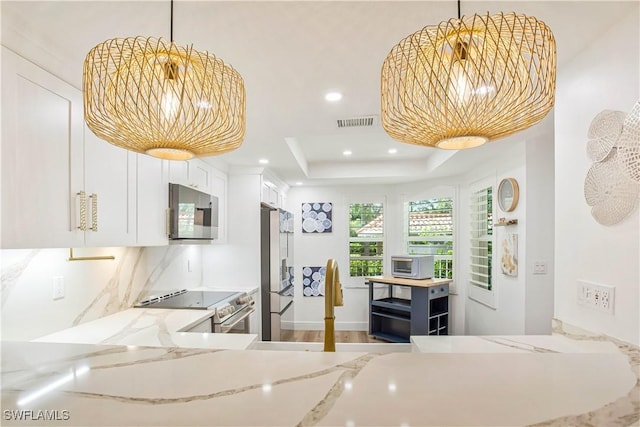kitchen with stainless steel appliances, a sink, white cabinetry, light stone countertops, and recessed lighting