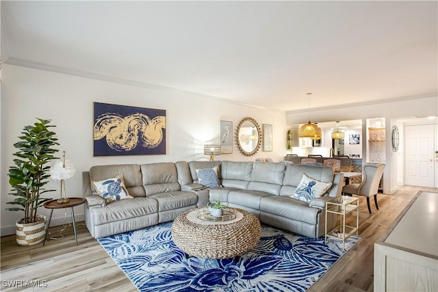 living room featuring light wood-type flooring and baseboards