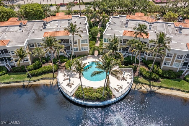 bird's eye view of a pool area and a large body of water