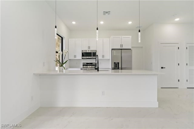kitchen with a sink, stainless steel appliances, white cabinetry, marble finish floor, and recessed lighting