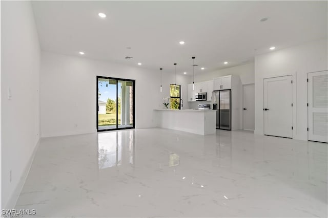 unfurnished living room featuring marble finish floor, baseboards, and recessed lighting