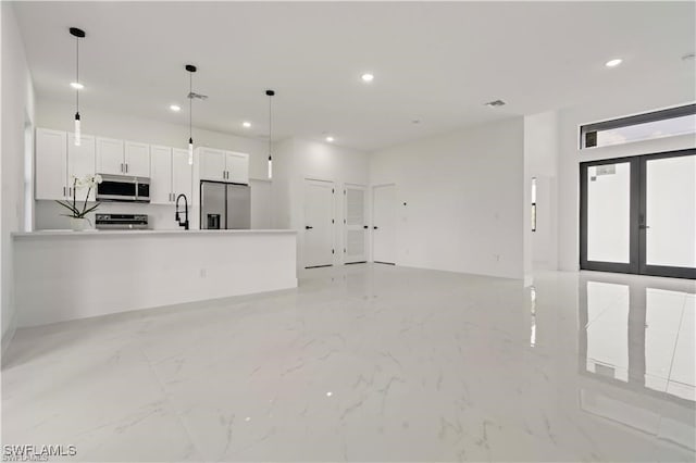 unfurnished living room featuring visible vents, marble finish floor, a sink, and recessed lighting