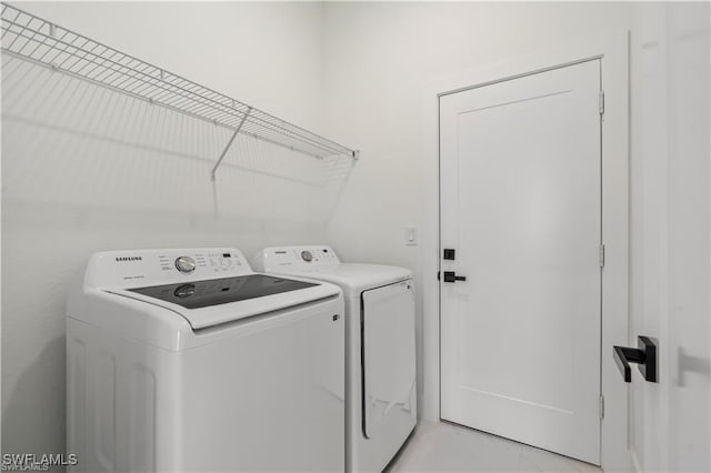 laundry room with washer and clothes dryer and laundry area