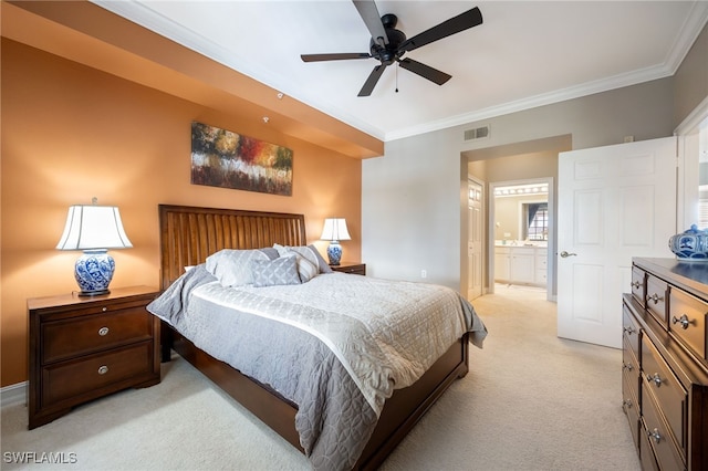 bedroom with crown molding, light carpet, ensuite bath, a ceiling fan, and baseboards