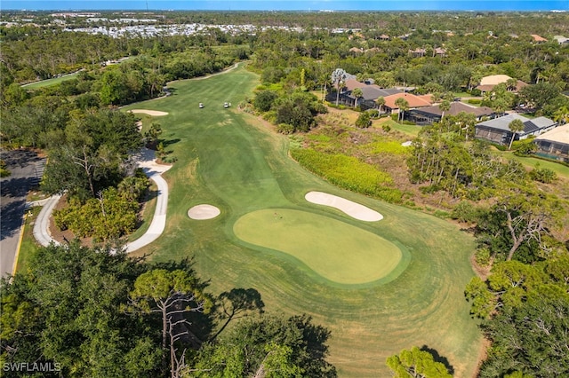 aerial overview of property's location featuring a local golf course and a tree filled landscape