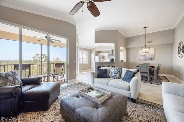 living area featuring ceiling fan, ornamental molding, light tile patterned floors, baseboards, and a chandelier