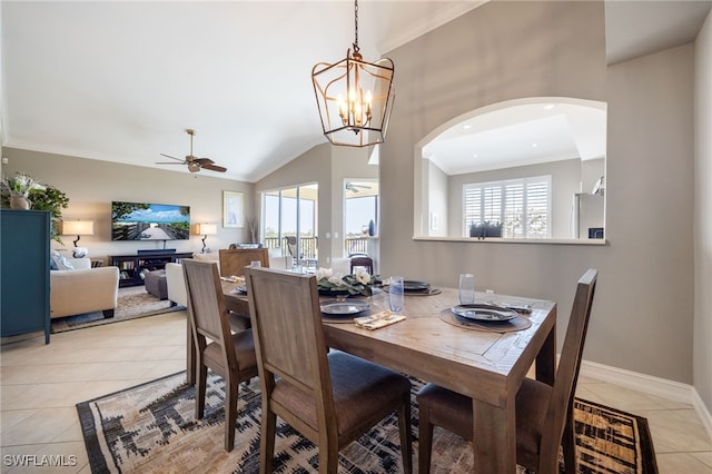 dining area featuring ceiling fan, plenty of natural light, light tile patterned floors, ornamental molding, and baseboards