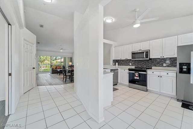 kitchen featuring stainless steel appliances, light countertops, ceiling fan, backsplash, and white cabinetry