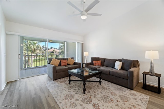 living room featuring ceiling fan, wood finished floors, lofted ceiling, and baseboards
