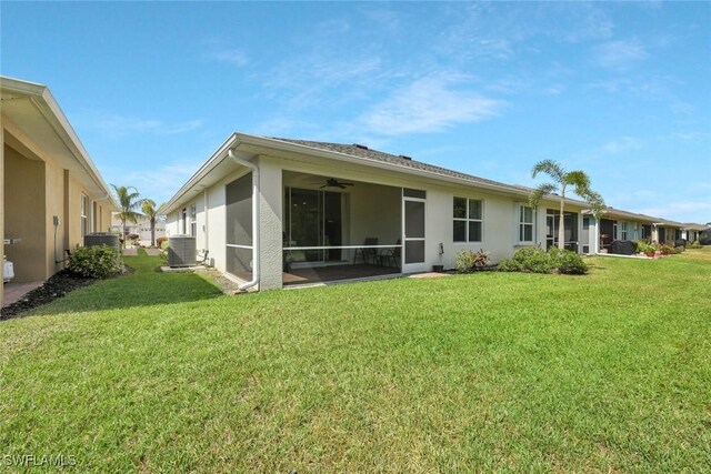 2036 Pigeon Plum Way N, Fort Myers, FL 33917 - rear view of house featuring a ceiling fan, stucco siding, and a lawn