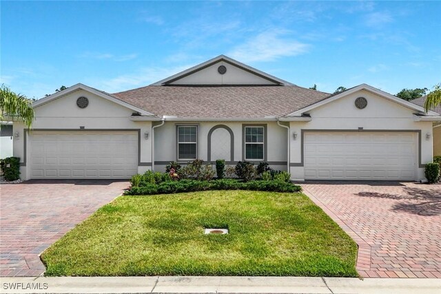 2036 Pigeon Plum Way N, Fort Myers, FL 33917 - ranch-style house with an attached garage, decorative driveway, and stucco siding