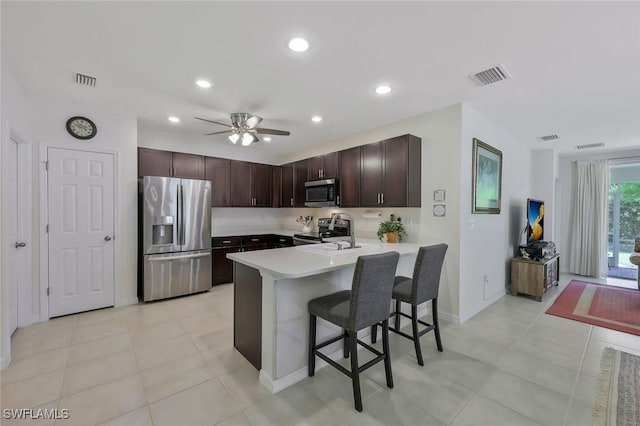 2036 Pigeon Plum Way N, Fort Myers, FL 33917 - kitchen featuring visible vents, a peninsula, a kitchen breakfast bar, light countertops, and appliances with stainless steel finishes