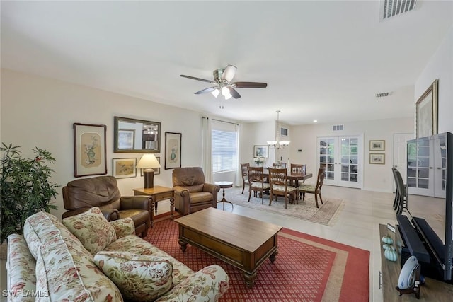 2036 Pigeon Plum Way N, Fort Myers, FL 33917 - living room featuring a healthy amount of sunlight, visible vents, and ceiling fan with notable chandelier