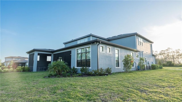 view of side of home featuring a yard and stucco siding