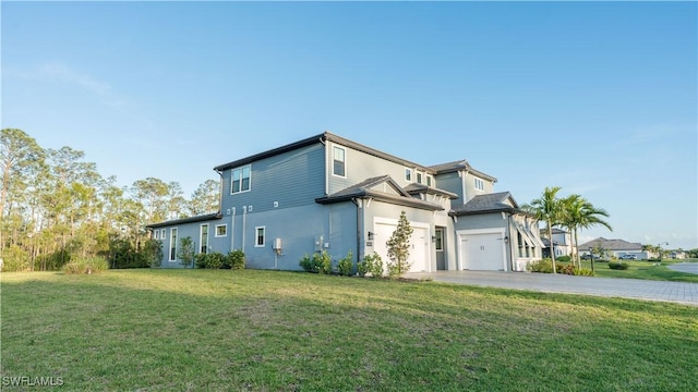 view of side of property featuring concrete driveway, a yard, stucco siding, and a garage