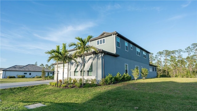 view of side of property featuring a lawn and stucco siding