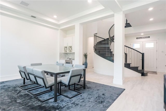dining area with recessed lighting, baseboards, visible vents, light wood-style floors, and stairway