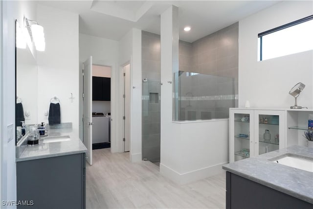 full bathroom with washing machine and dryer, baseboards, walk in shower, vanity, and recessed lighting