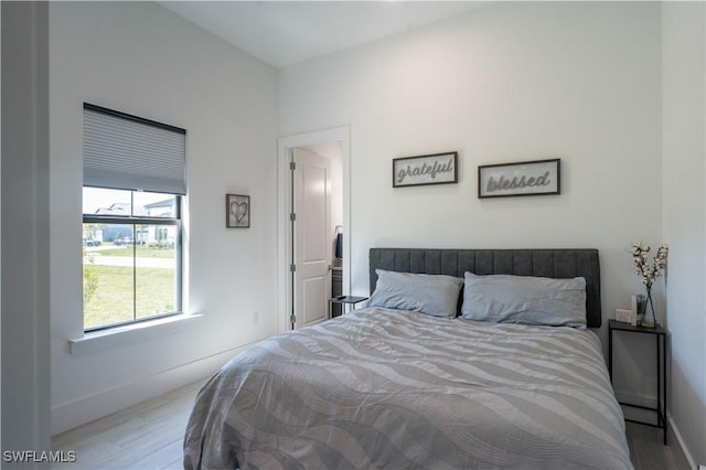 bedroom featuring wood finished floors and baseboards