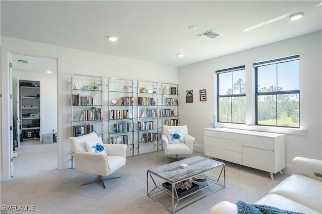 sitting room with carpet flooring, visible vents, and recessed lighting