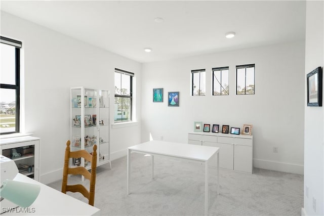 office space with light carpet and baseboards