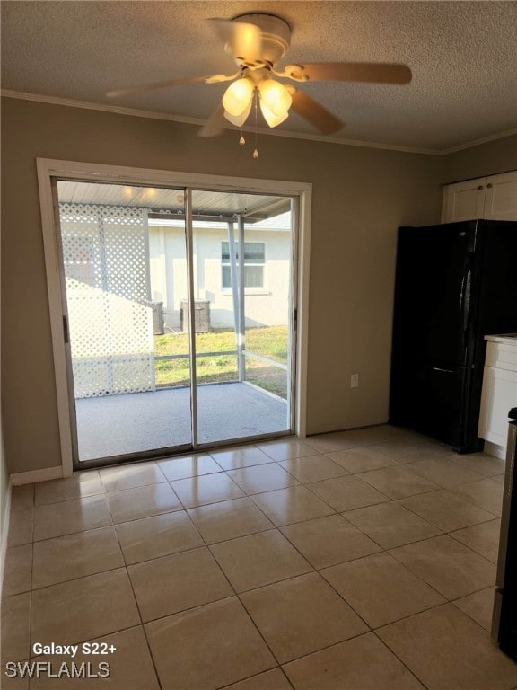 16901 Juanita Ave, Fort Myers, FL 33908 - unfurnished dining area with ceiling fan, a textured ceiling, light tile patterned floors, and ornamental molding
