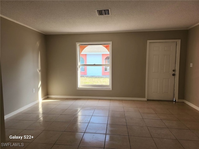 16901 Juanita Ave, Fort Myers, FL 33908 - empty room featuring tile patterned floors, crown molding, a textured ceiling, visible vents, and baseboards
