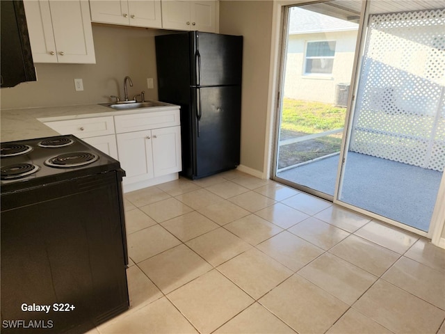 16901 Juanita Ave, Fort Myers, FL 33908 - kitchen featuring white cabinets, black appliances, and a sink