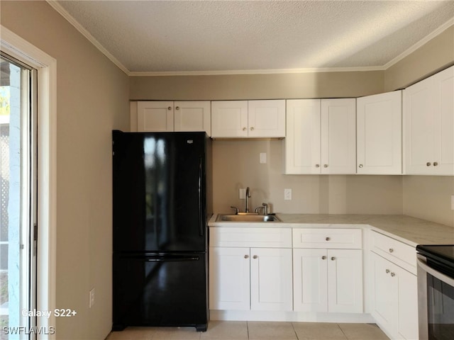 16901 Juanita Ave, Fort Myers, FL 33908 - kitchen featuring a sink, freestanding refrigerator, crown molding, white cabinetry, and stainless steel range with electric cooktop