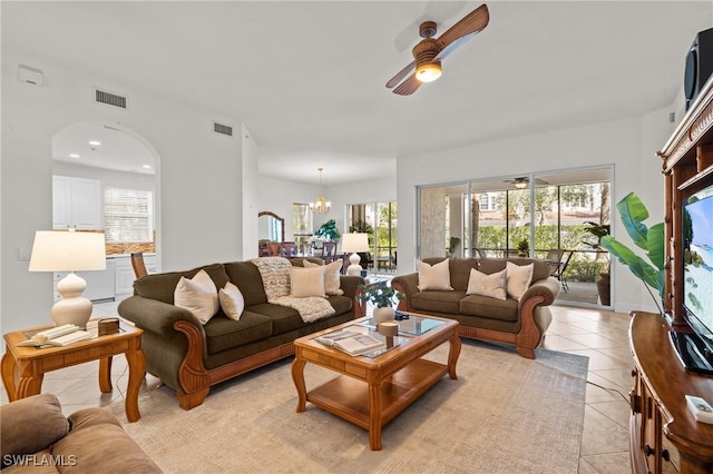 9083 Cascada Way Unit 101, Naples, FL 34114 - living area with ceiling fan, light tile patterned floors, arched walkways, and a chandelier