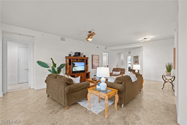 9083 Cascada Way Unit 101, Naples, FL 34114 - living room featuring light tile patterned floors and baseboards