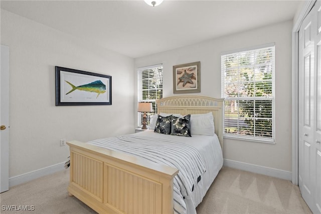 9083 Cascada Way Unit 101, Naples, FL 34114 - bedroom featuring light colored carpet, baseboards, and a closet