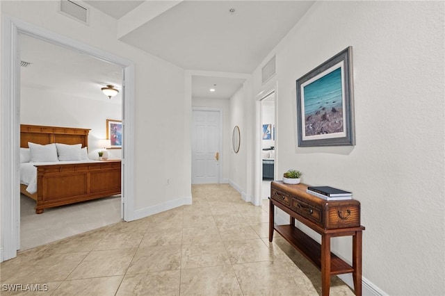 9083 Cascada Way Unit 101, Naples, FL 34114 - hallway featuring light tile patterned floors and baseboards