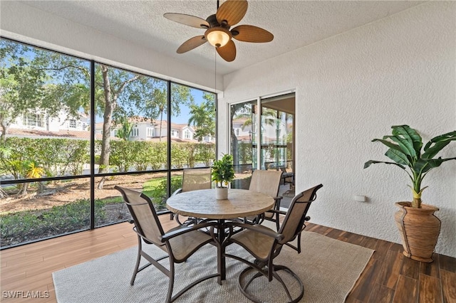 9083 Cascada Way Unit 101, Naples, FL 34114 - sunroom featuring a textured wall, a textured ceiling, and wood finished floors
