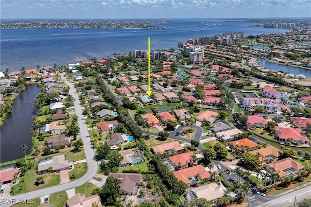 birds eye view of property with a water view and a residential view