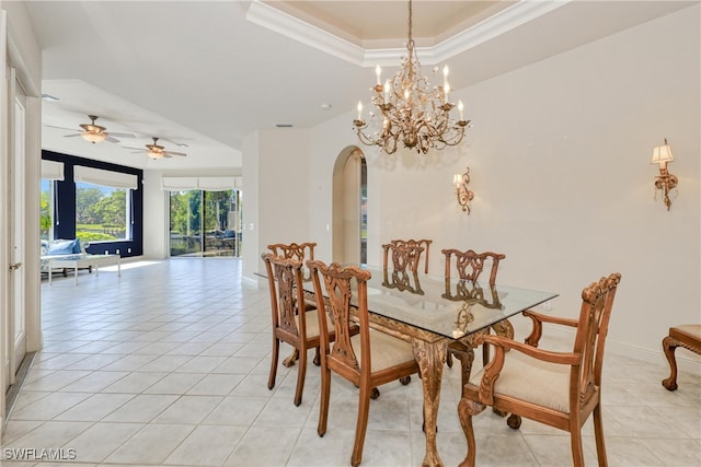 dining area featuring light tile patterned floors, a tray ceiling, crown molding, and ceiling fan with notable chandelier