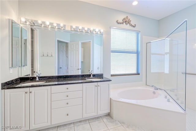 bathroom featuring a sink, tile patterned floors, a garden tub, double vanity, and an enclosed shower