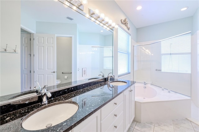 bathroom featuring toilet, visible vents, a bathing tub, and a sink