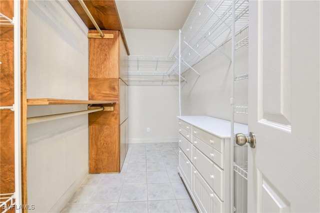 spacious closet with light tile patterned floors