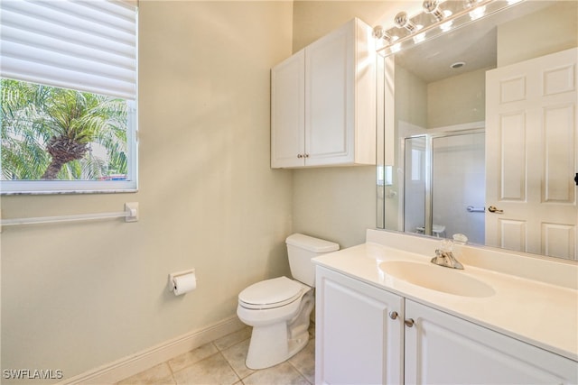 bathroom with toilet, tile patterned floors, baseboards, a shower stall, and vanity