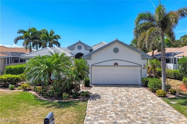 view of front of home with a front yard, an attached garage, stucco siding, and driveway