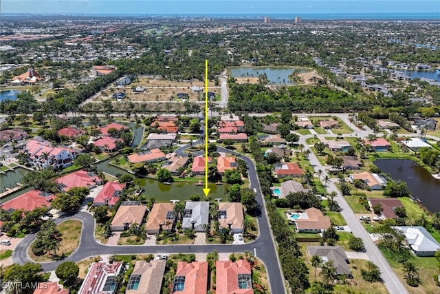 drone / aerial view with a water view and a residential view