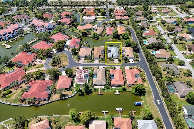 drone / aerial view featuring a water view and a residential view