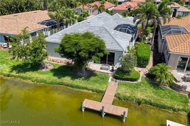 drone / aerial view with a water view and a residential view