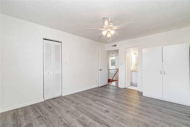 5816 Whiting Ct, Fort Myers, FL 33919 - unfurnished bedroom featuring light wood finished floors, baseboards, ensuite bathroom, and a ceiling fan