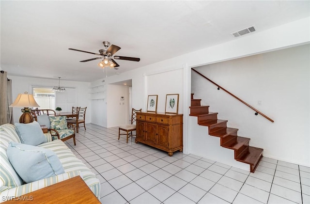 5816 Whiting Ct, Fort Myers, FL 33919 - living area with ceiling fan, stairway, light tile patterned flooring, and a chandelier