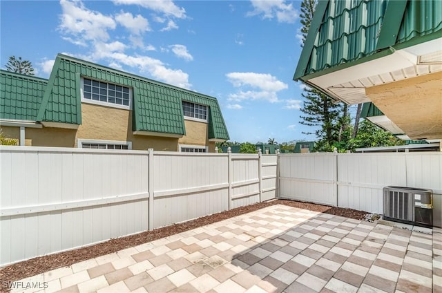 5816 Whiting Ct, Fort Myers, FL 33919 - view of patio / terrace with central AC unit and a fenced backyard