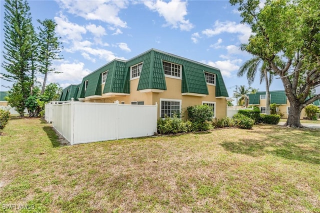 5816 Whiting Ct, Fort Myers, FL 33919 - rear view of property featuring mansard roof and stucco siding